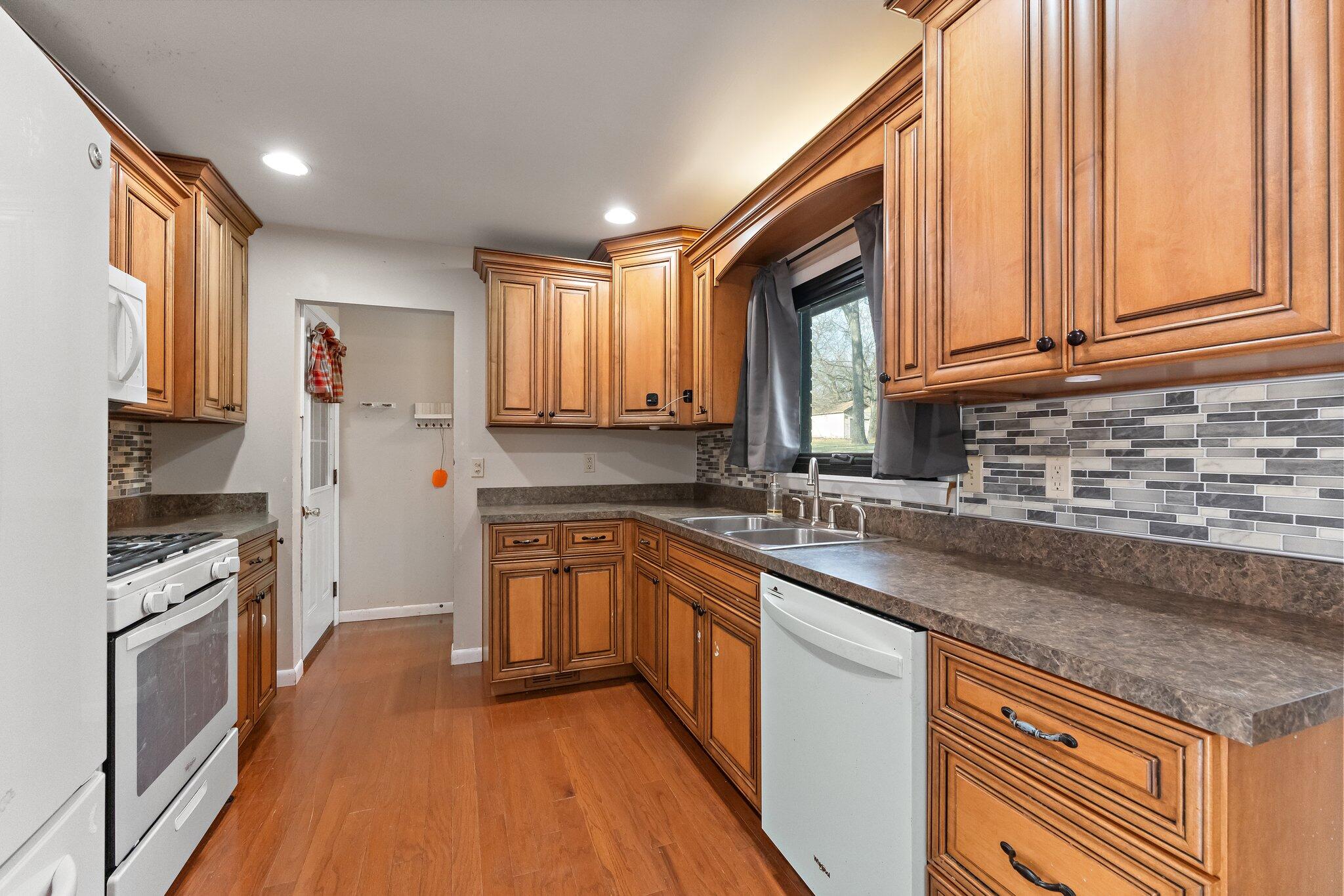 12163 North 900 West Demotte, IN 46310 - Photo 6 of 23 a kitchen with stainless steel appliances granite countertop a stove a sink and a granite counter tops
