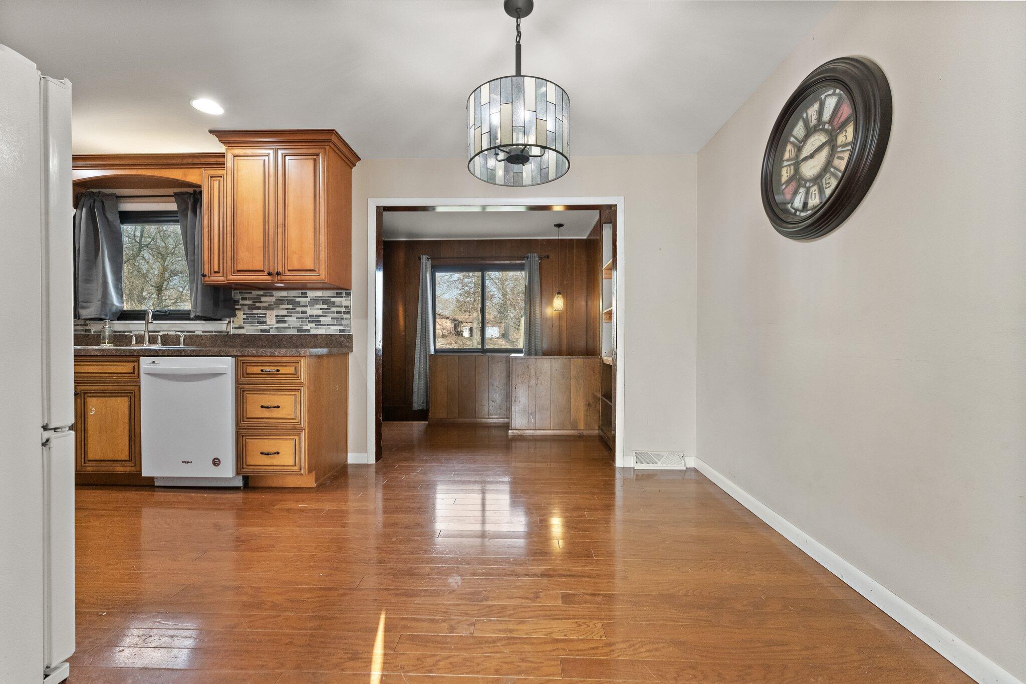 12163 North 900 West Demotte, IN 46310 - Photo 9 of 23 an empty room with wooden floor mirror and windows