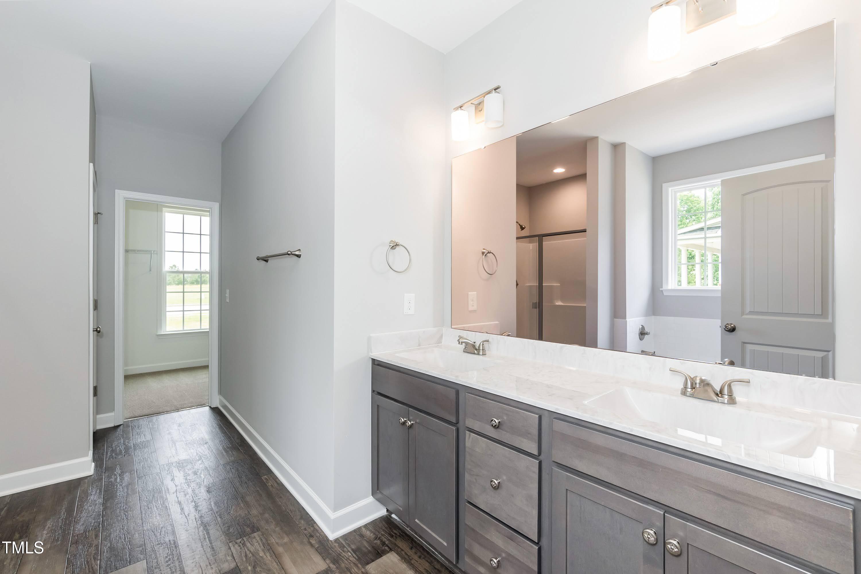 748 Rivers Edge Parkway Roanoke Rapids, NC 27870 - Photo 11 of 42 a spacious bathroom with a double vanity sink and mirror