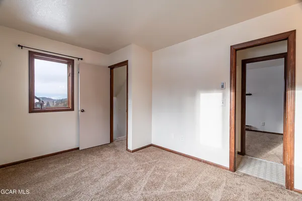 an empty room with windows and closet