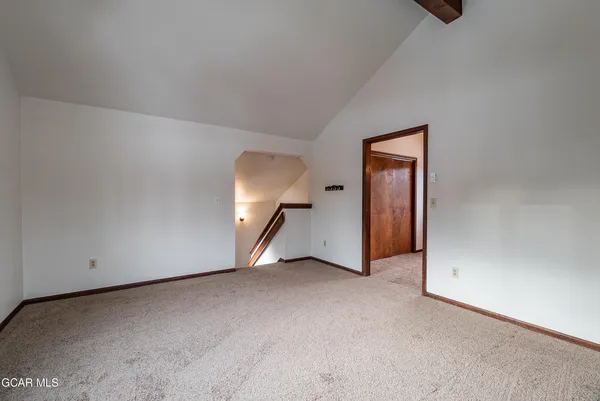 a view of an empty room and wooden door