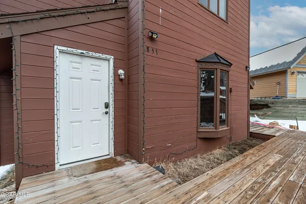 a view of a house with a door and wooden floor