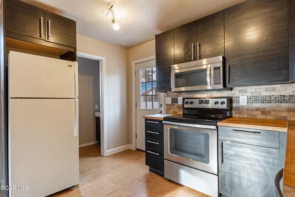 a kitchen with a refrigerator stove and microwave