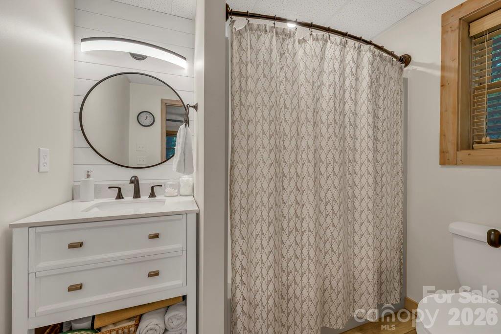 192 Dewitt Barnett Road, Unit 2 Vilas, NC 28692 - Photo 31 of 32 a bathroom with a sink a mirror and a shower curtain