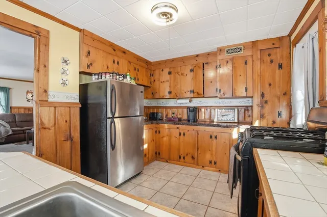 a kitchen with stainless steel appliances granite countertop a refrigerator and a stove