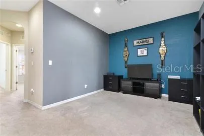 a bedroom with furniture and a flat screen tv