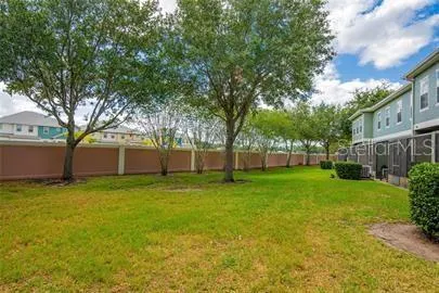 a view of a yard with a house and large trees