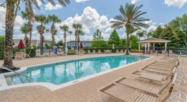 a view of swimming pool with a table and chairs