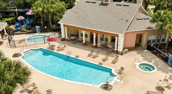 swimming pool view with a seating space and a garden