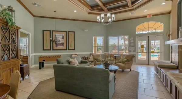 a living room with furniture and a chandelier