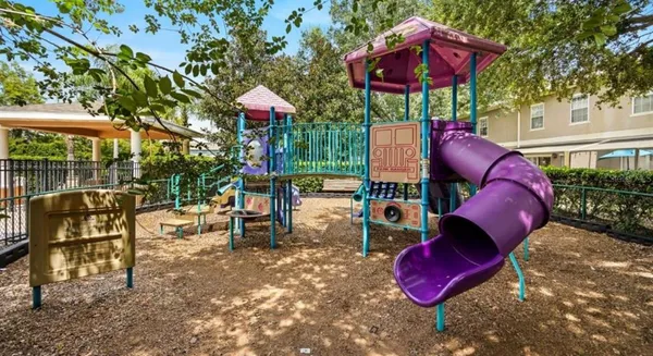 a view of a chairs and table in backyard