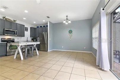 a view of kitchen with refrigerator microwave and cabinets