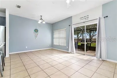 an empty room that has a large window and chandelier