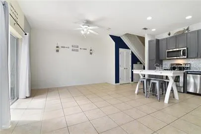 a kitchen with stainless steel appliances kitchen island granite countertop a refrigerator and a stove top oven