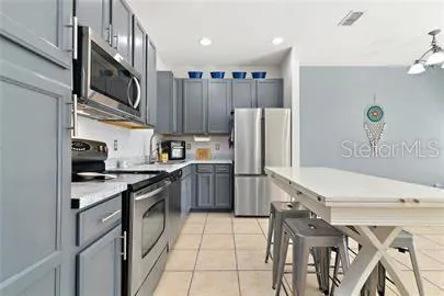 a kitchen with a refrigerator a sink and a stove