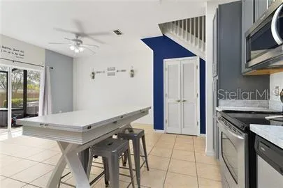 a kitchen with kitchen island a stove a refrigerator and a sink