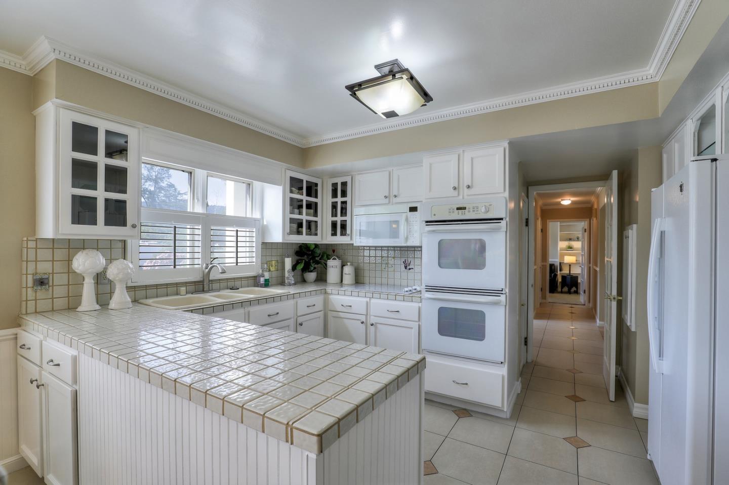 19923 Lanark Lane Saratoga, CA 95070 - Photo 11 of 34 a kitchen with stainless steel appliances granite countertop a stove and more cabinets