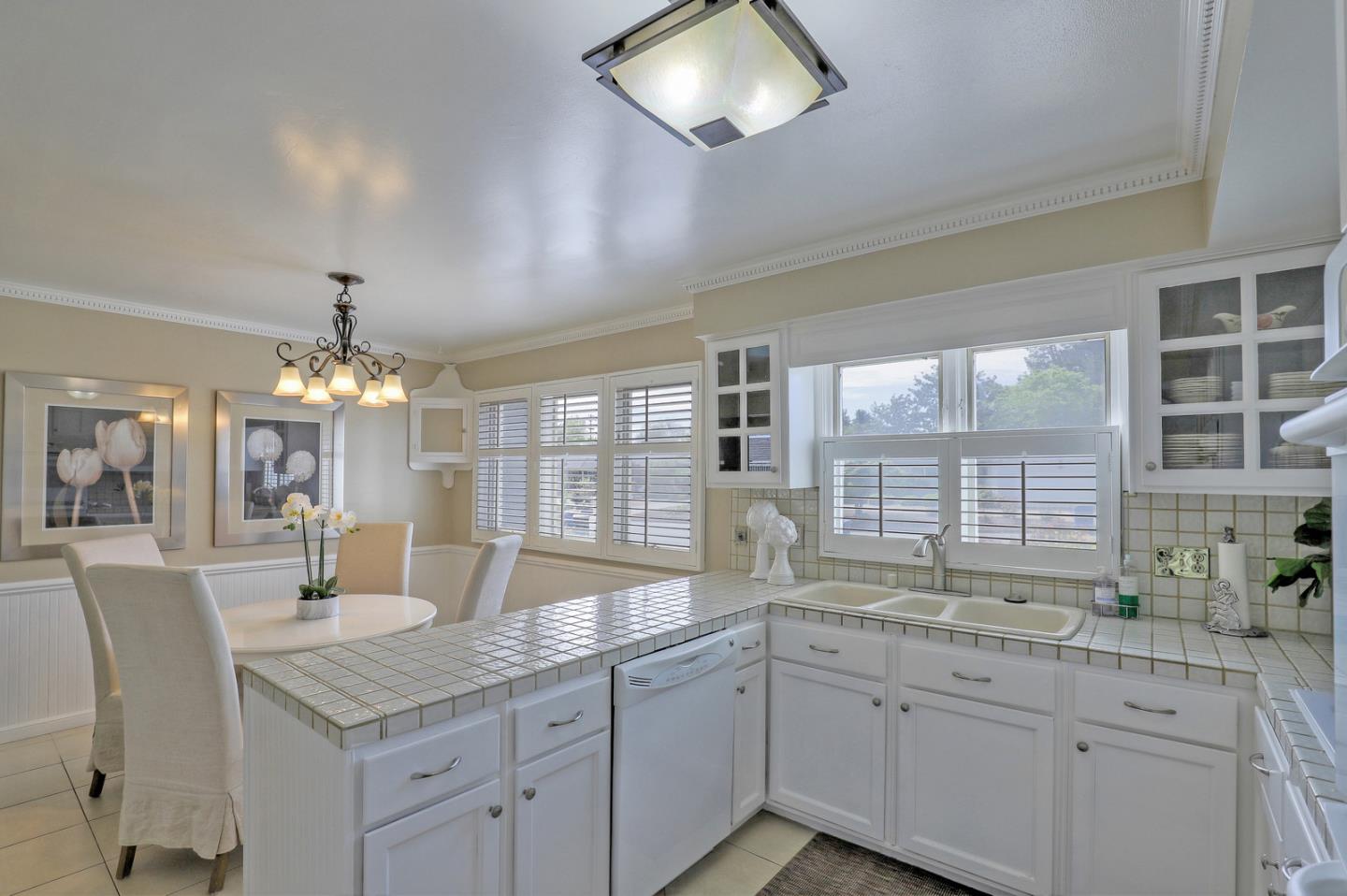 19923 Lanark Lane Saratoga, CA 95070 - Photo 14 of 34 a dining hall with stainless steel appliances granite countertop a kitchen island a stove and a sink