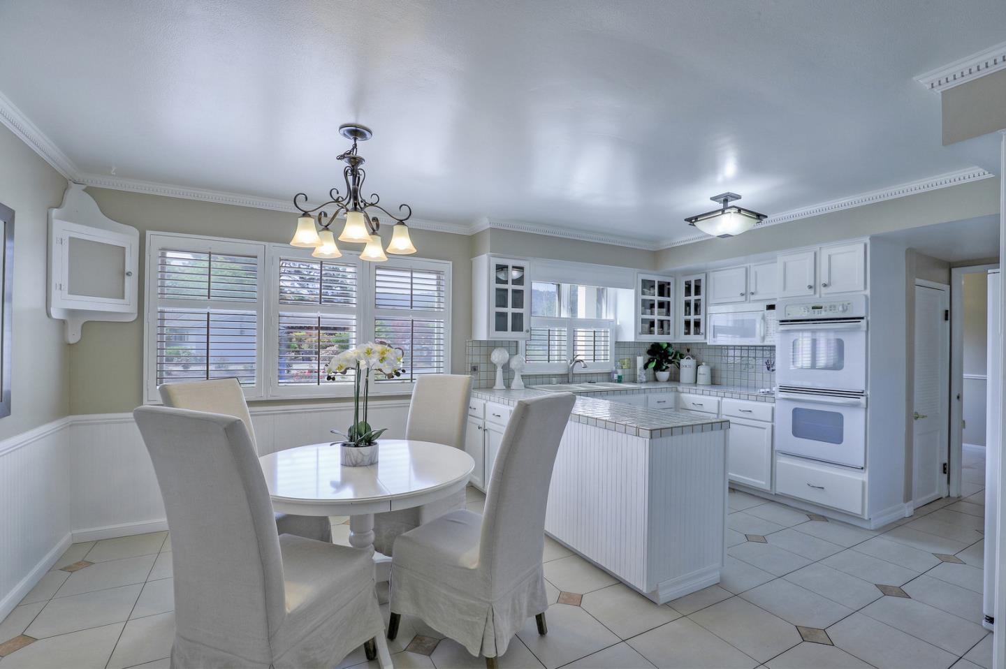 19923 Lanark Lane Saratoga, CA 95070 - Photo 15 of 34 a view of a dining room with furniture window and wooden floor