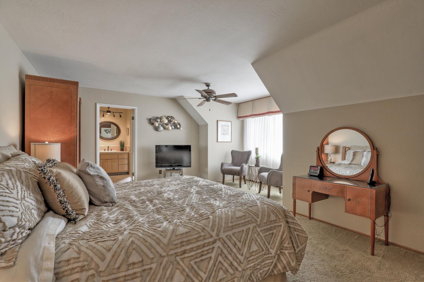 19923 Lanark Lane Saratoga, CA 95070 - Photo 20 of 34 a bed room with a bed a mirror and a table