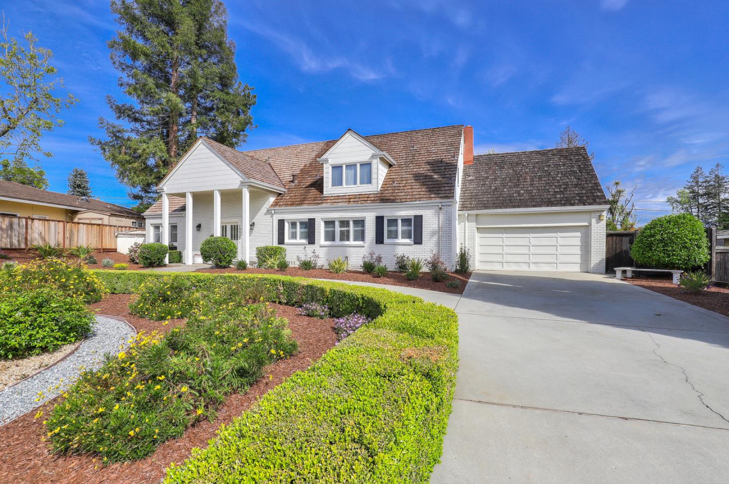 19923 Lanark Lane Saratoga, CA 95070 - Photo 2 of 34 a front view of a house with yard porch and seating
