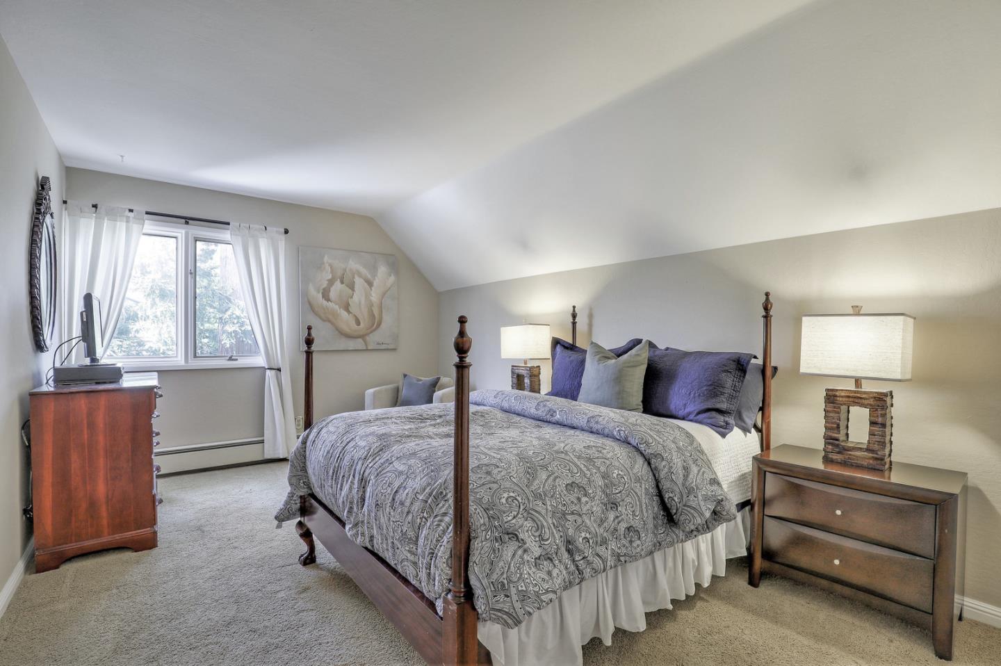 19923 Lanark Lane Saratoga, CA 95070 - Photo 22 of 34 a bedroom with a bed and a dresser with mirror