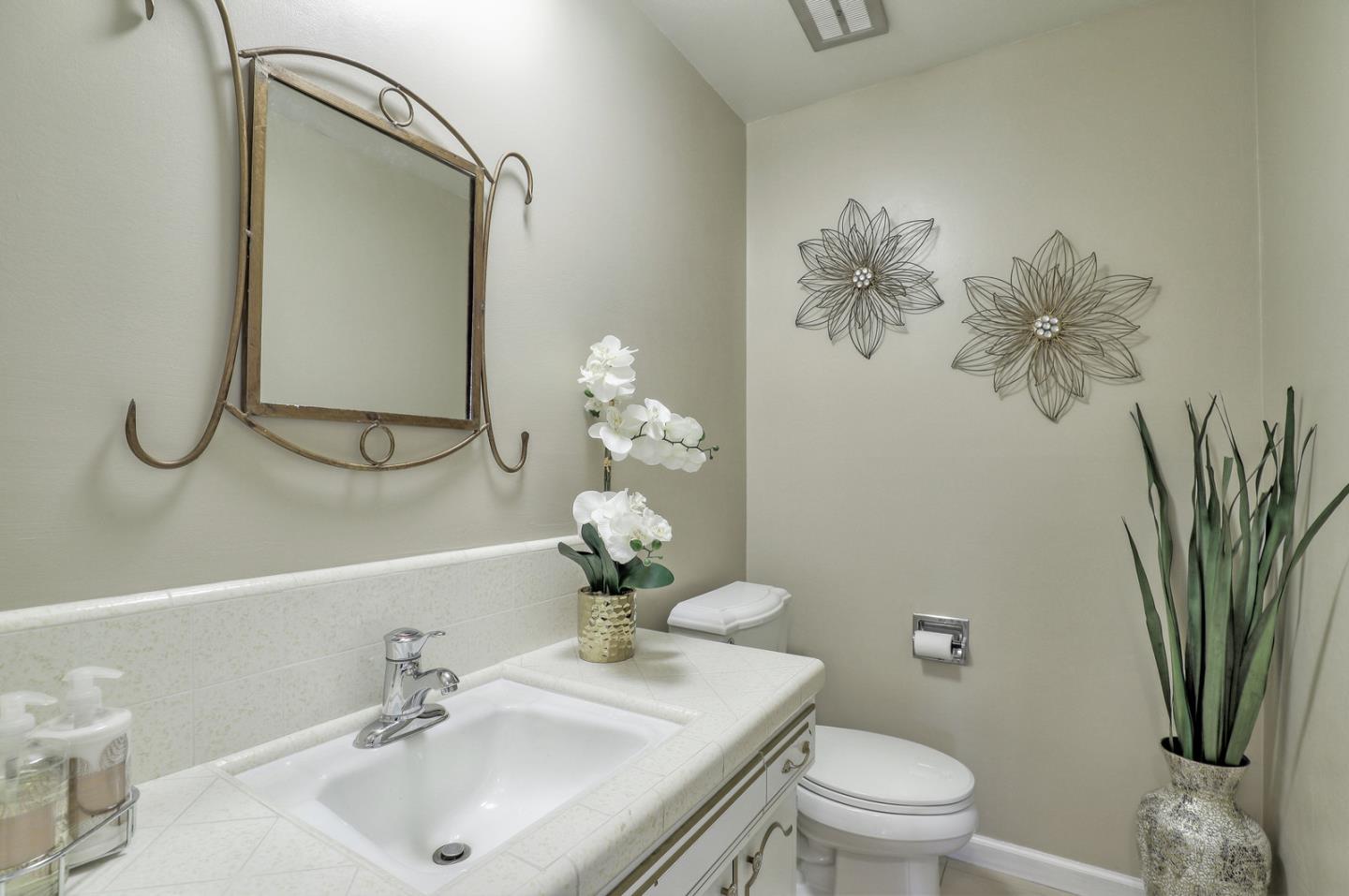 19923 Lanark Lane Saratoga, CA 95070 - Photo 24 of 34 a bathroom with a toilet sink and mirror