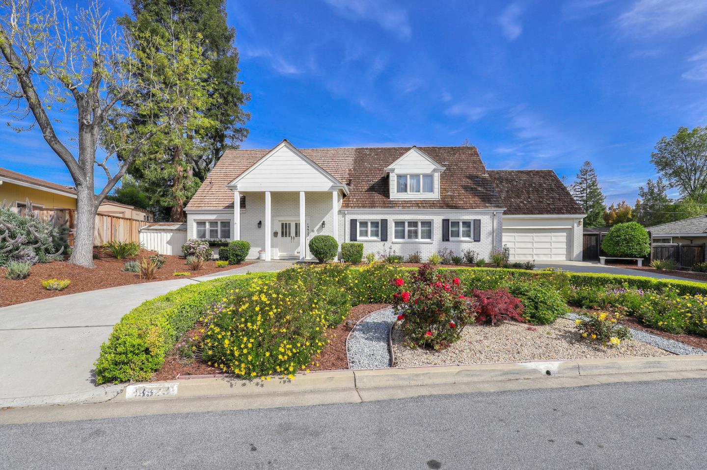 19923 Lanark Lane Saratoga, CA 95070 - Photo 3 of 34 a front view of a house with a garden