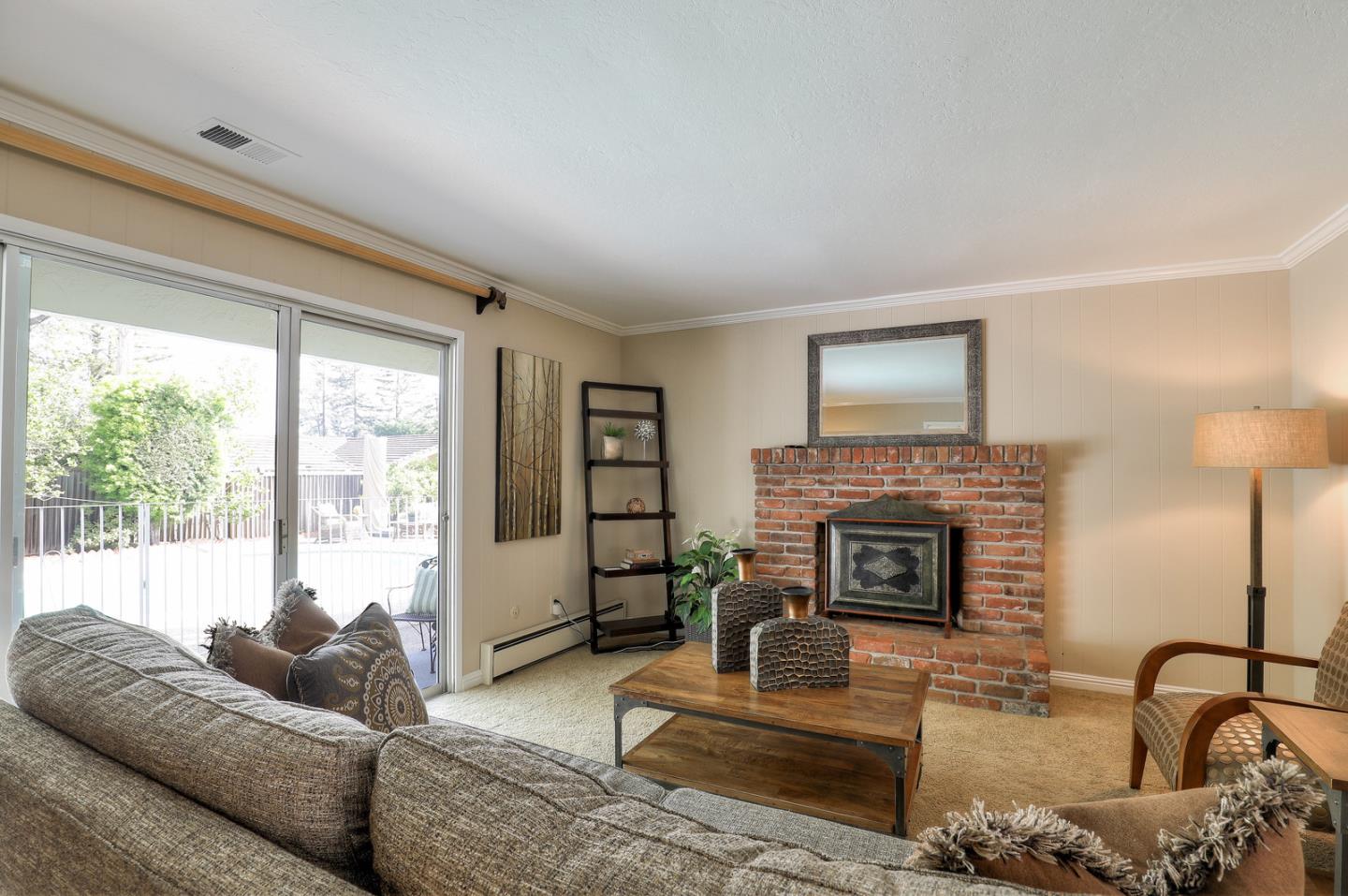 19923 Lanark Lane Saratoga, CA 95070 - Photo 10 of 34 a living room with furniture and a fireplace