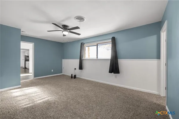 a view of an empty room with windows