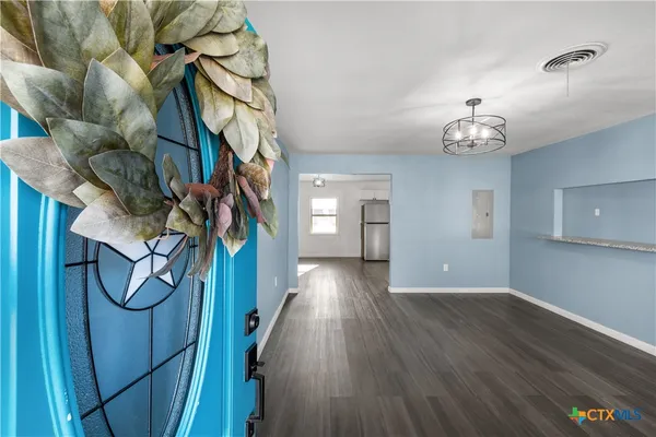 a view of a hallway with wooden floor