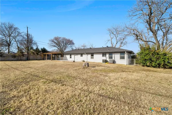 a front view of house with yard and trees around