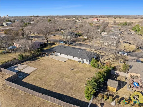 an aerial view of residential houses with outdoor space