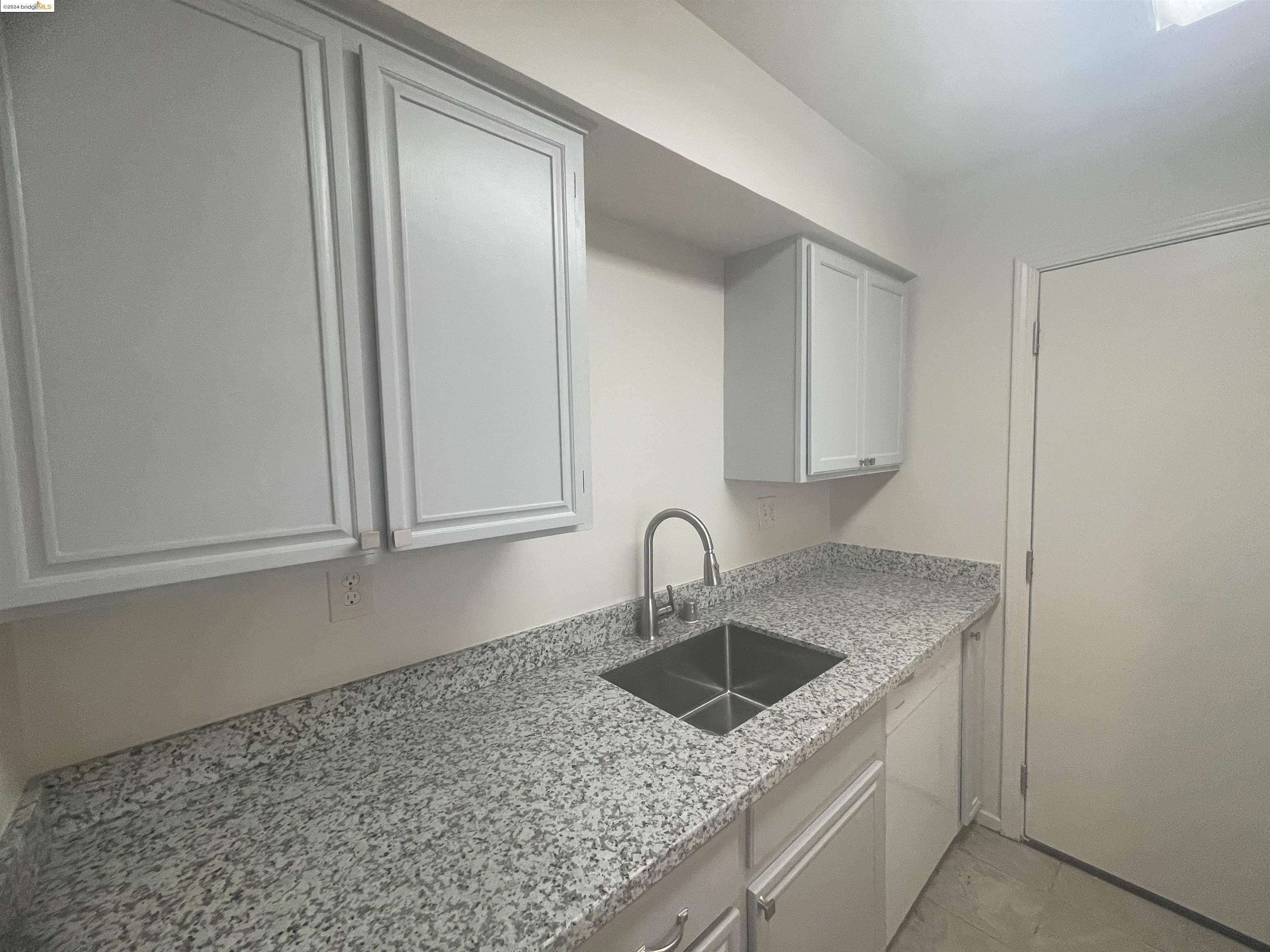 1096 Mohr Lane Concord, CA 94518 - Photo 17 of 34 a kitchen with granite countertop a sink and cabinets