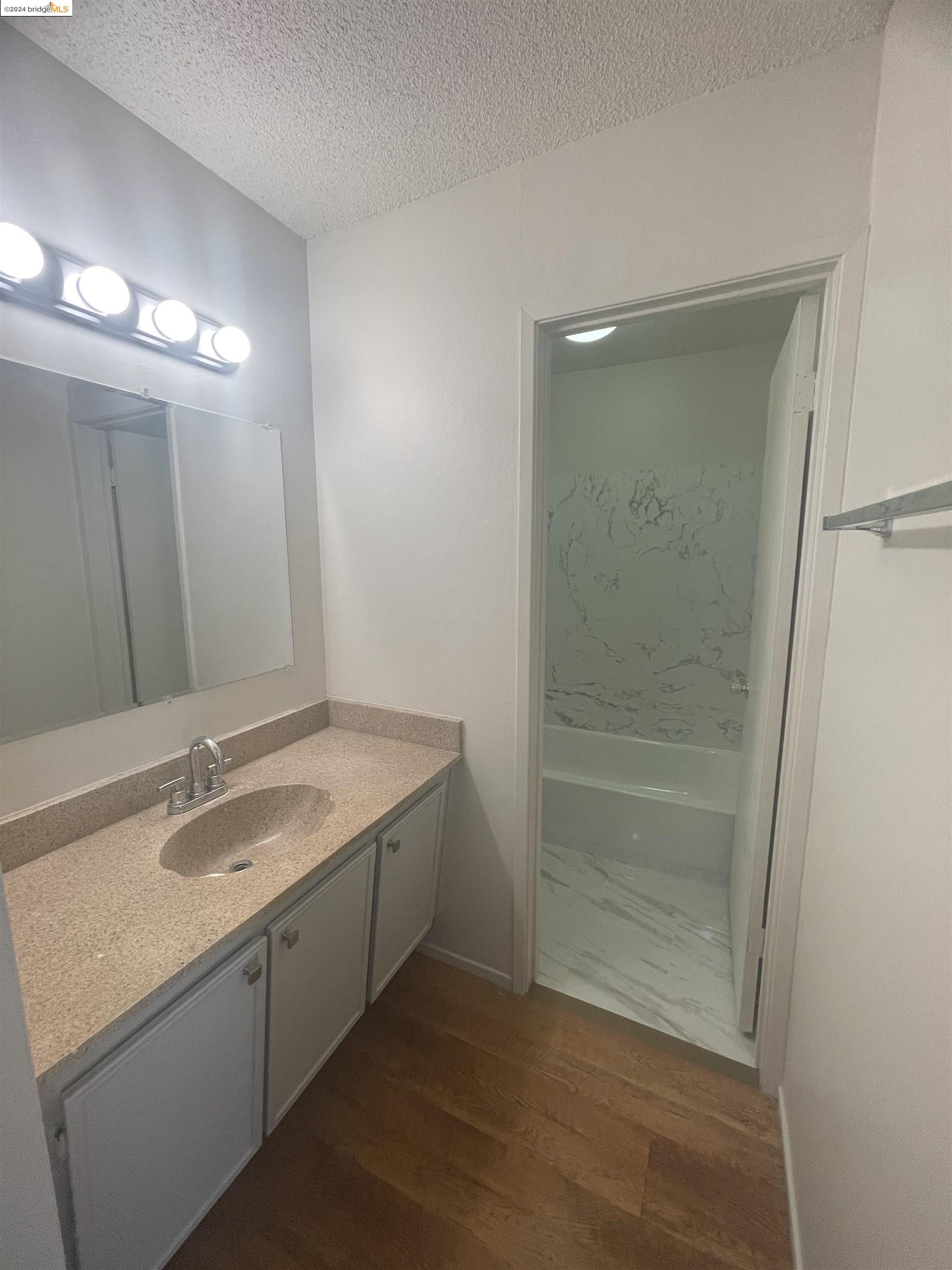 1096 Mohr Lane Concord, CA 94518 - Photo 26 of 34 a bathroom with a granite countertop sink and a mirror