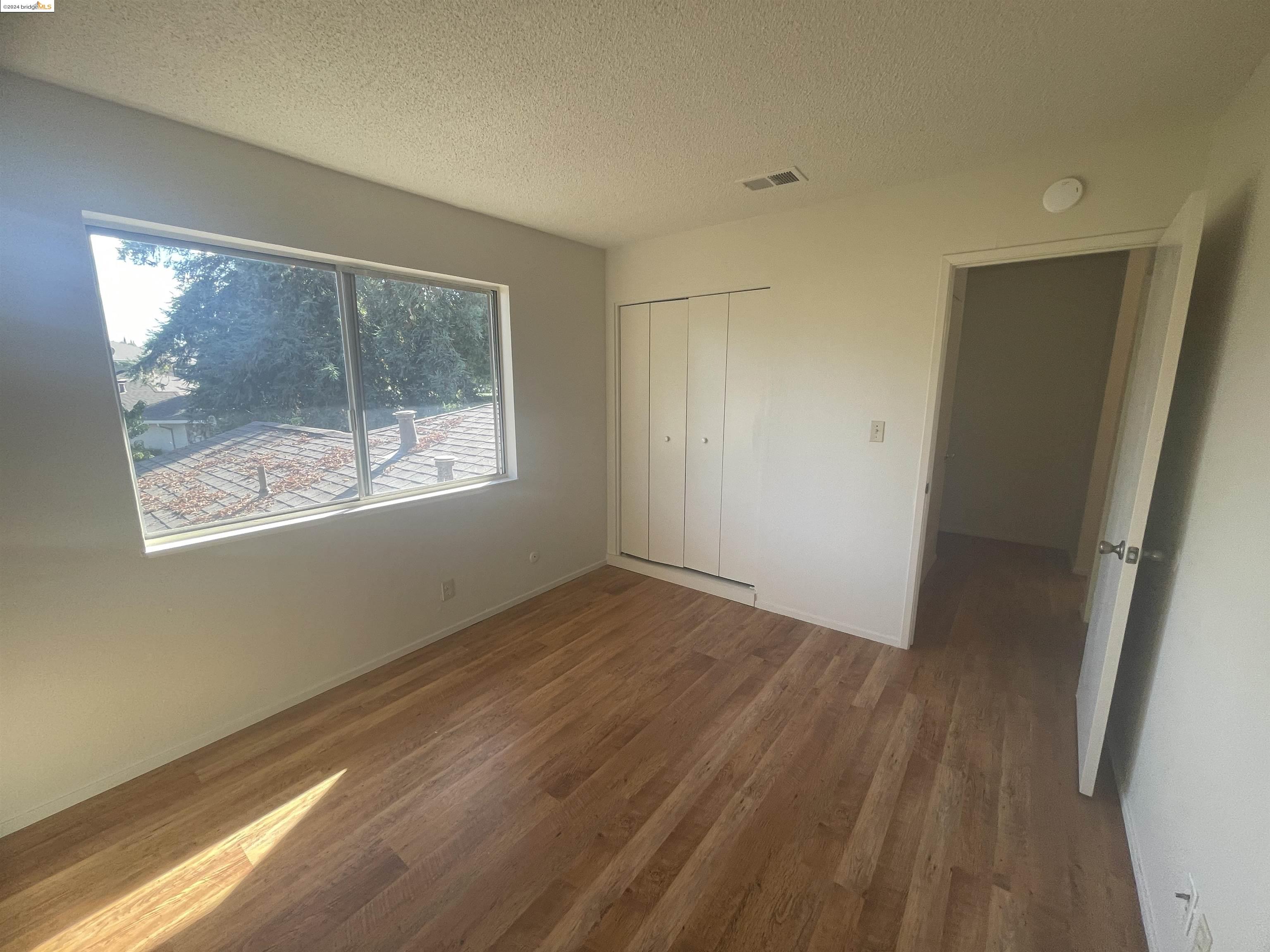 1096 Mohr Lane Concord, CA 94518 - Photo 28 of 34 a view of an empty room with wooden floor and a window