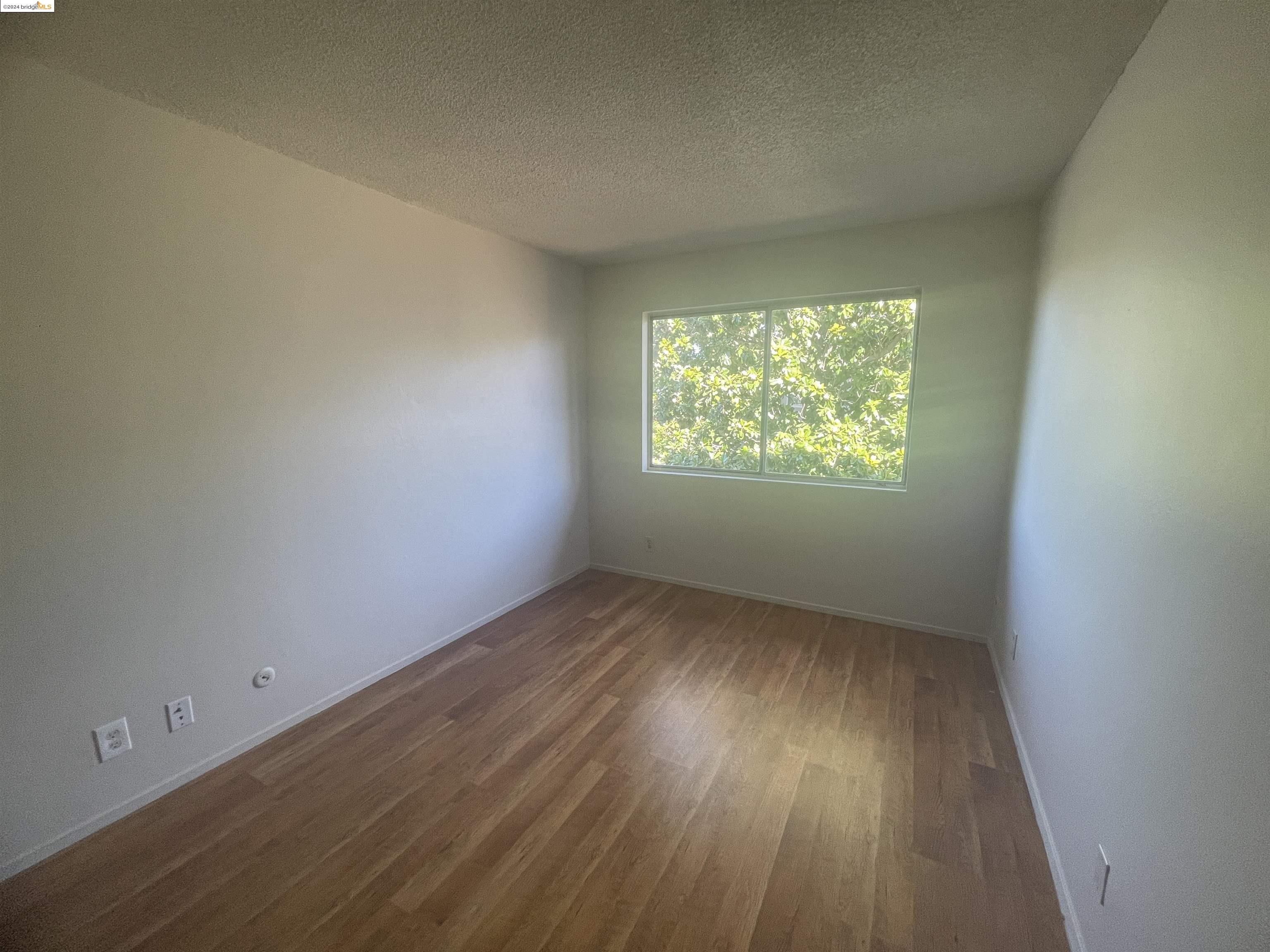 1096 Mohr Lane Concord, CA 94518 - Photo 29 of 34 an empty room with wooden floor and windows