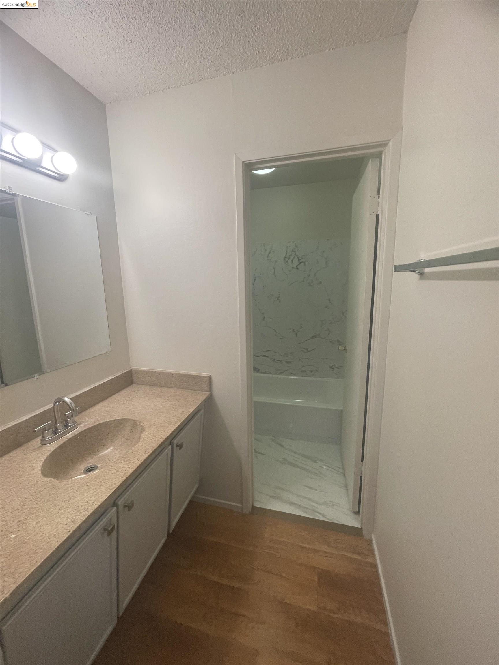 1096 Mohr Lane Concord, CA 94518 - Photo 32 of 34 a bathroom with a granite countertop sink a toilet and shower