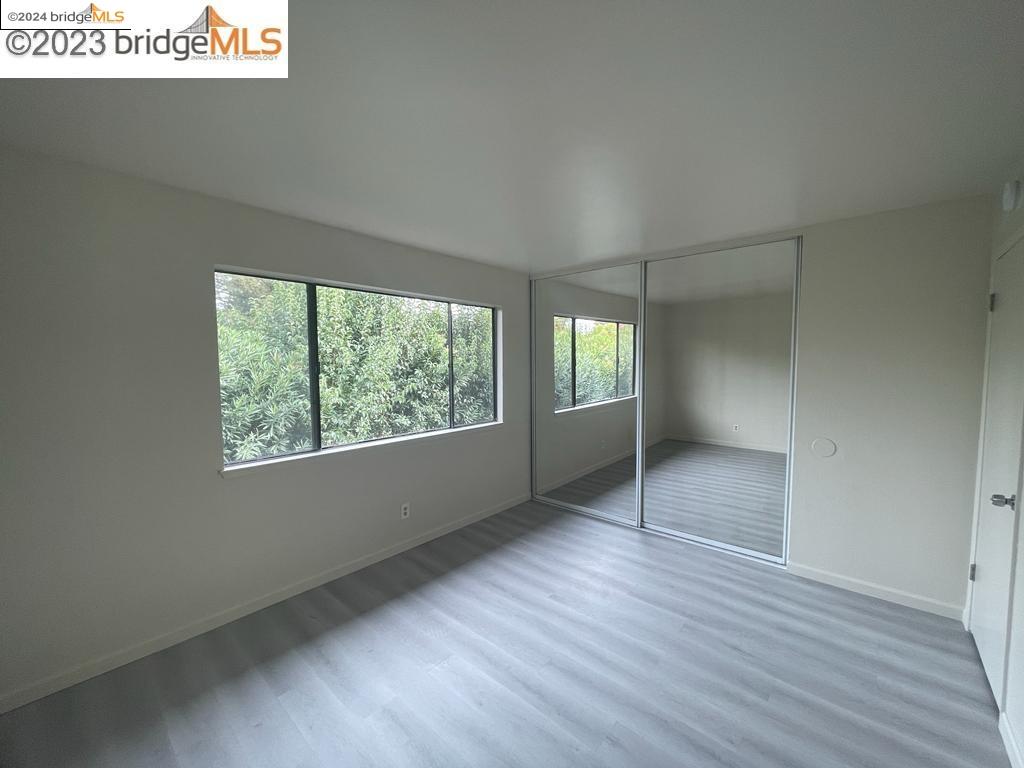 1096 Mohr Lane Concord, CA 94518 - Photo 8 of 34 an empty room with wooden floor and windows