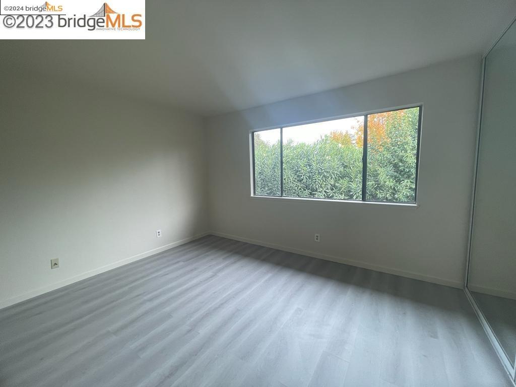 1096 Mohr Lane Concord, CA 94518 - Photo 9 of 34 an empty room with wooden floor and windows