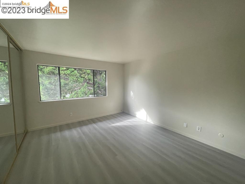 1096 Mohr Lane Concord, CA 94518 - Photo 10 of 34 an empty room with wooden floor and windows