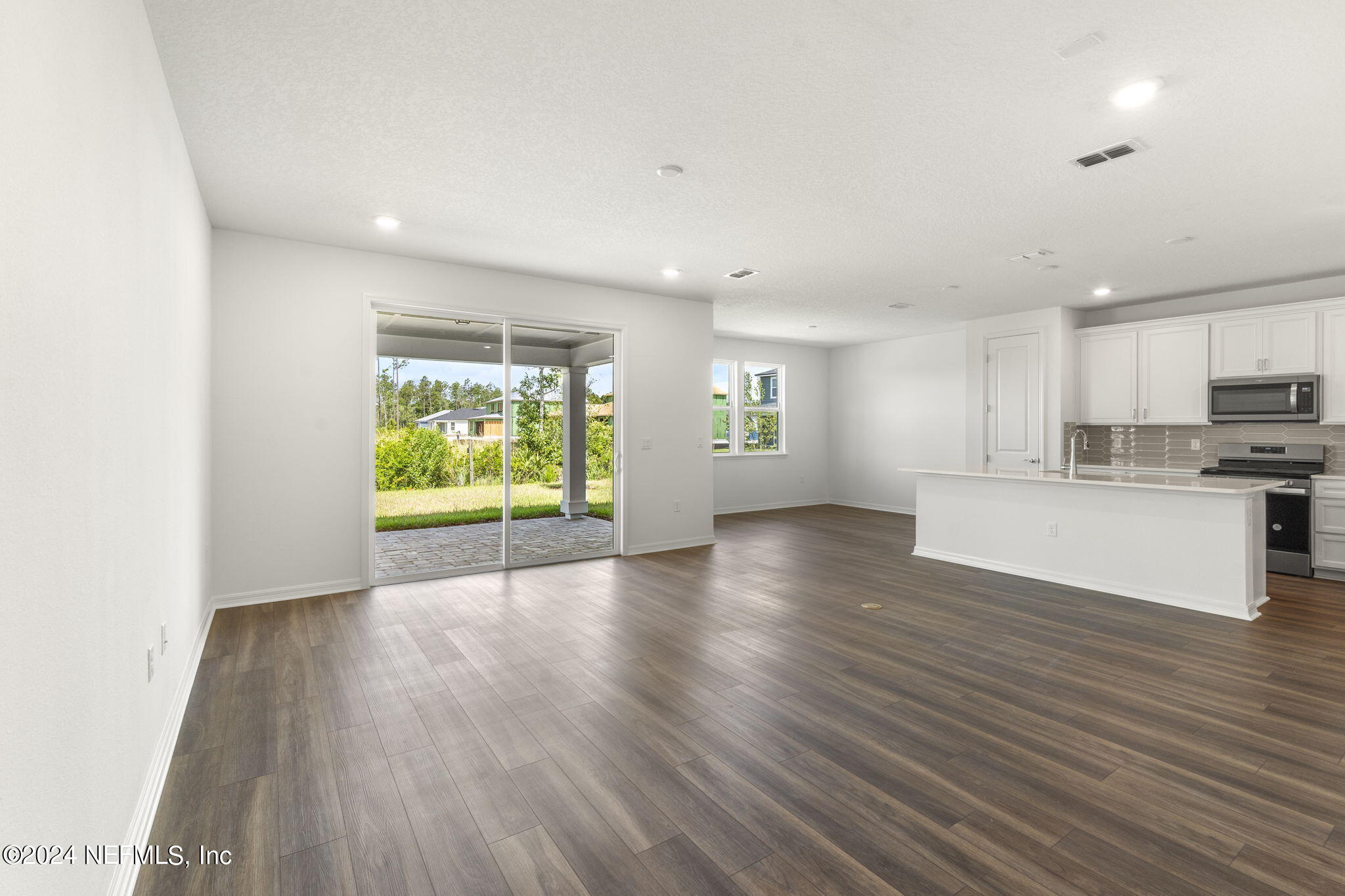 54 Torres Trace St. Augustine, FL 32095 - Photo 6 of 31 a view of kitchen with wooden floor and window