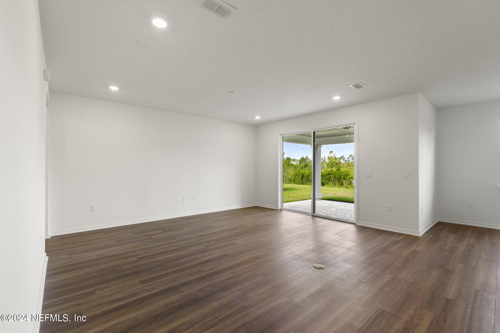 54 Torres Trace St. Augustine, FL 32095 - Photo 8 of 31 a view of an empty room with wooden floor and a window