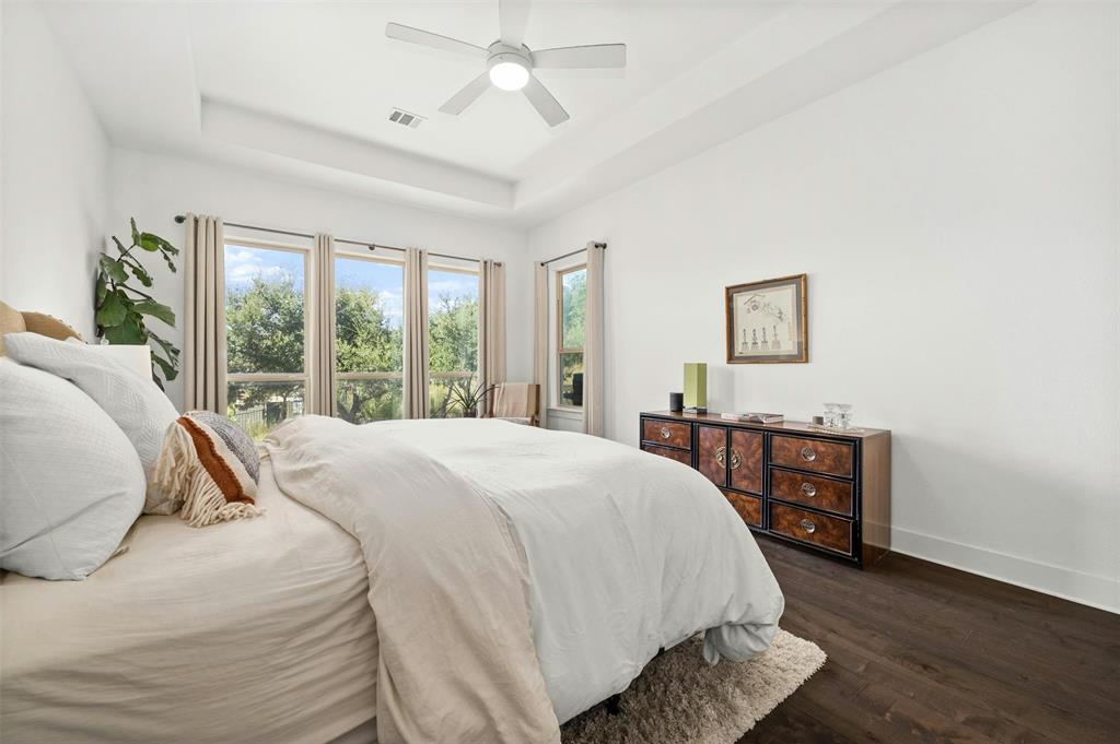 208 Slate Rock Terrace Austin, TX 78738 - Photo 20 of 29 a bed sitting in a spacious bedroom next to a window