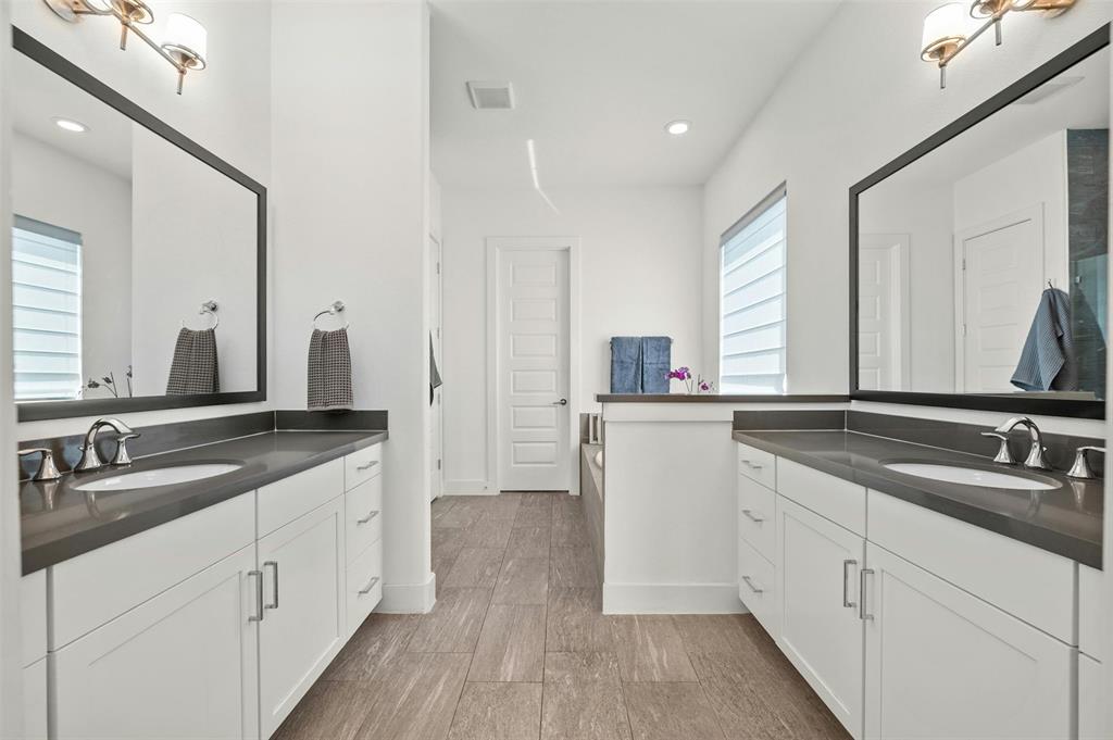 208 Slate Rock Terrace Austin, TX 78738 - Photo 21 of 29 a bathroom with a double vanity sink and mirror