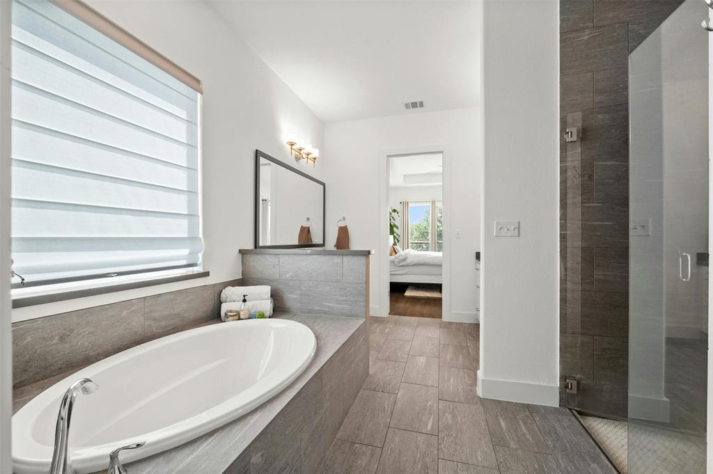 208 Slate Rock Terrace Austin, TX 78738 - Photo 22 of 29 a bathroom with a bathtub and a sink