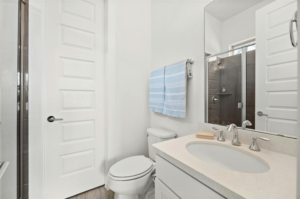 208 Slate Rock Terrace Austin, TX 78738 - Photo 28 of 29 a bathroom with a sink toilet and shower