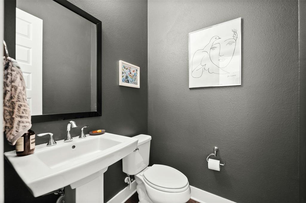 208 Slate Rock Terrace Austin, TX 78738 - Photo 29 of 29 a bathroom with a toilet a sink and mirror