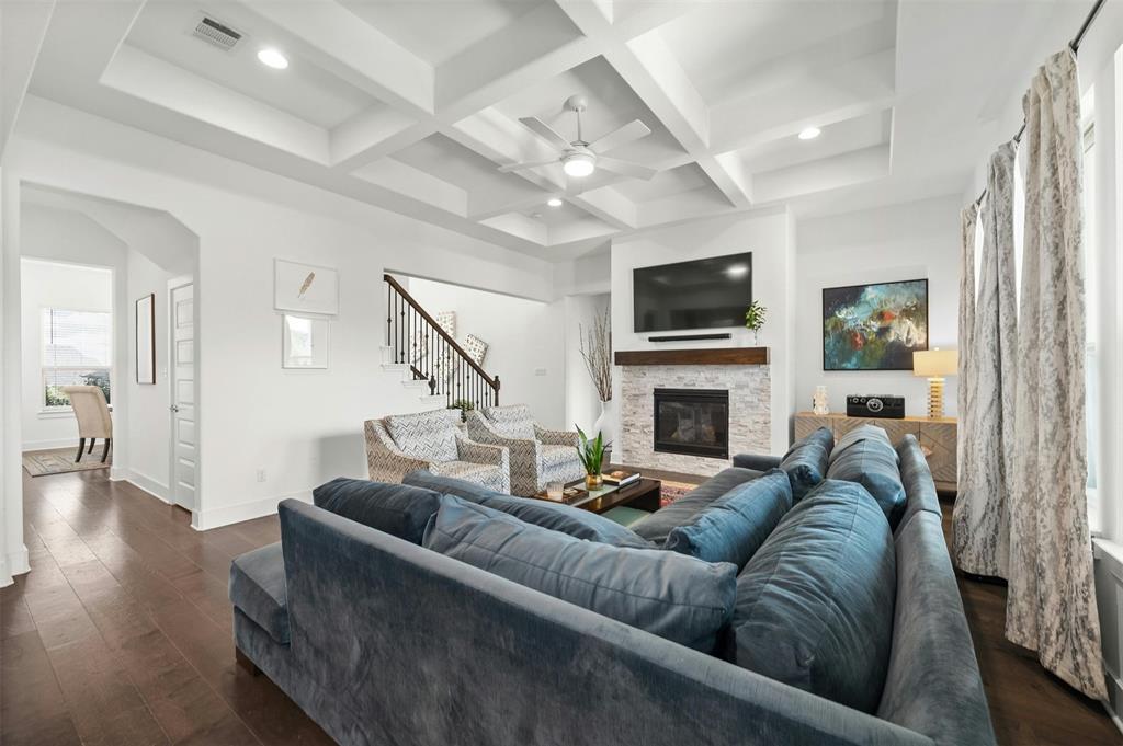 208 Slate Rock Terrace Austin, TX 78738 - Photo 4 of 29 a living room with furniture a flat screen tv and a fireplace