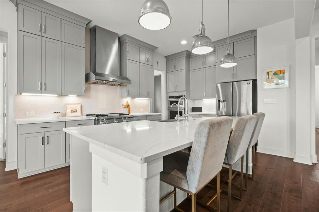208 Slate Rock Terrace Austin, TX 78738 - Photo 8 of 29 a kitchen with kitchen island granite countertop a sink a center island and cabinets